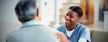 Healthcare worker talks with male patient.